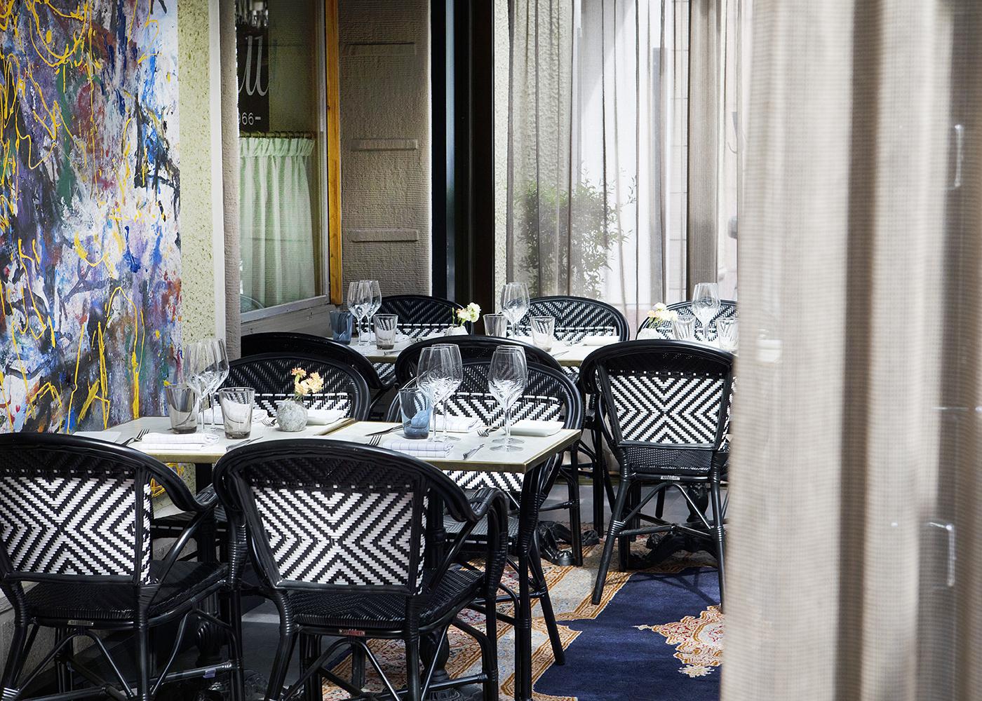 Restaurant Kuu's interior. Tables, and on the left side a painting can be seen.