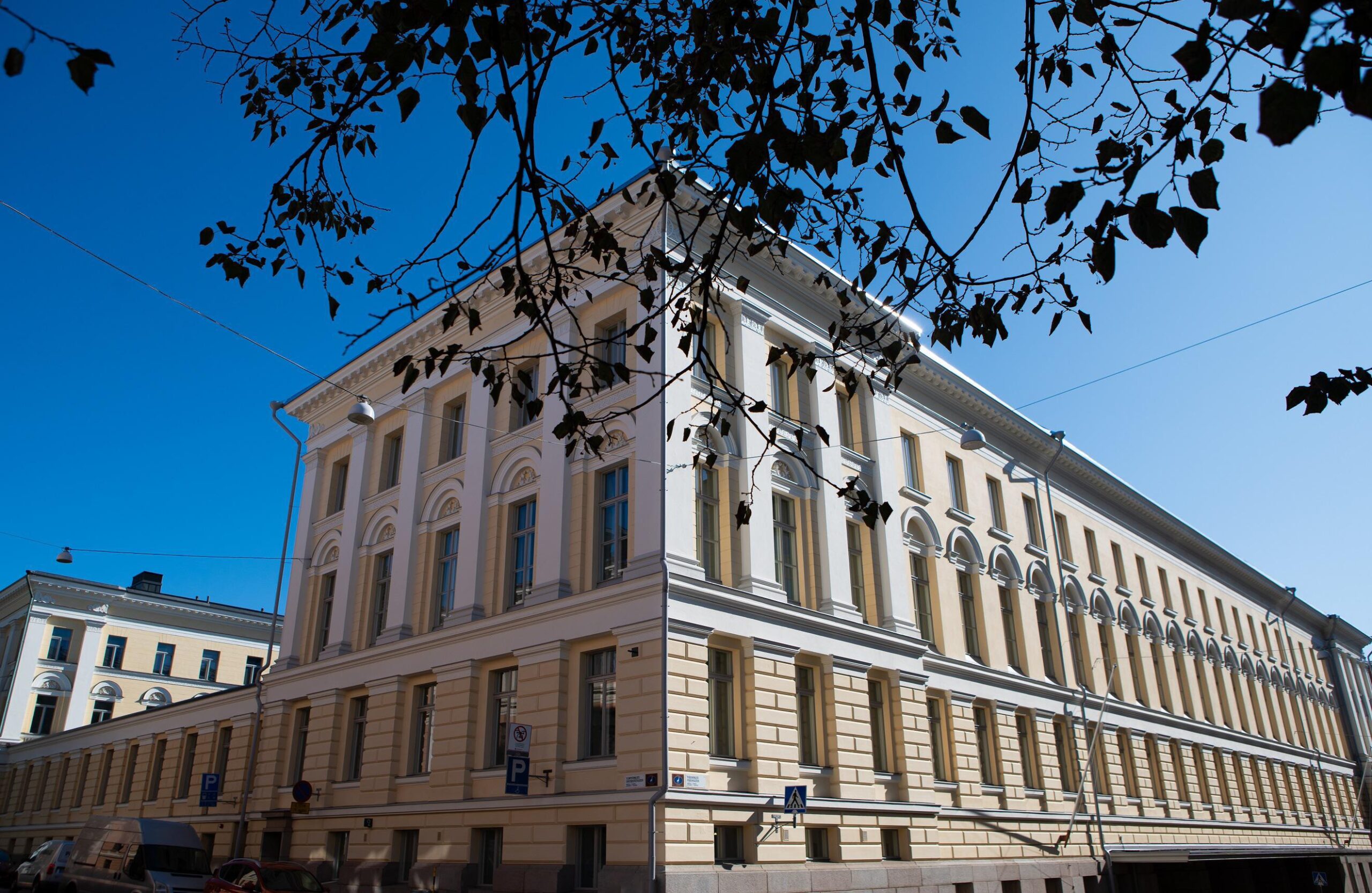 The Helsinki University Museum Flame. A light coloured building, blue sky in the background.