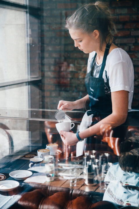 Girl making coffee in Helsinki cafe