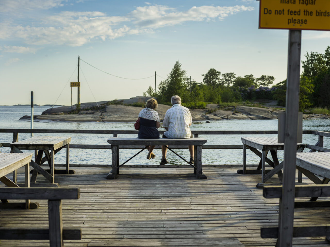 Couple sitting on a dock bench