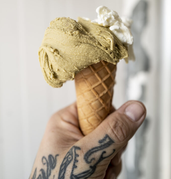 a hand holding an ice cream cone