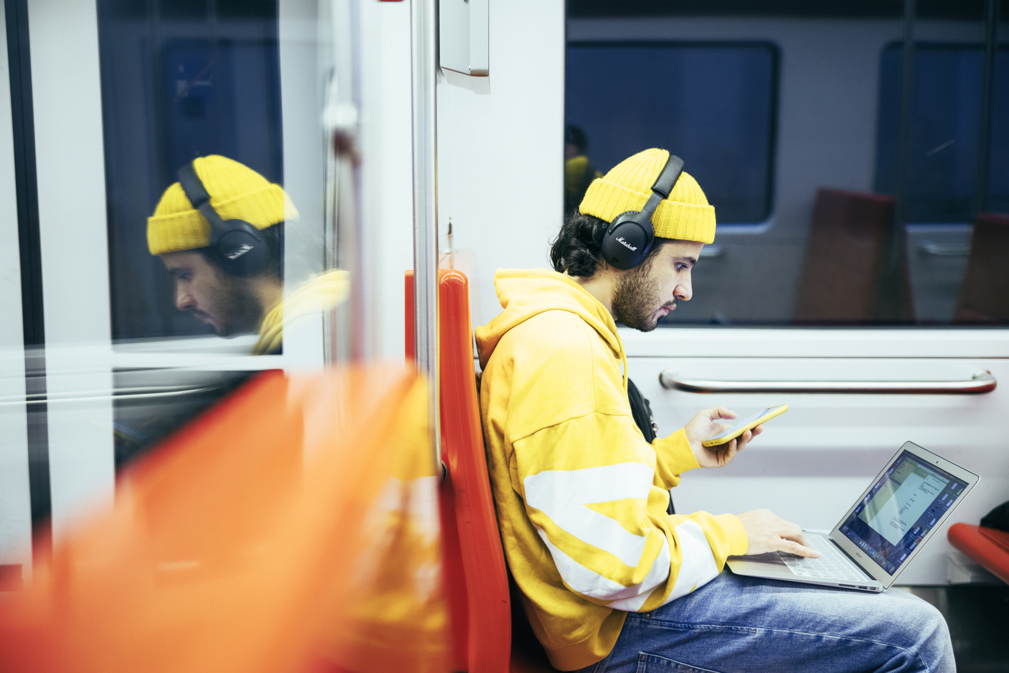 Man in a yellow outfit with a computer