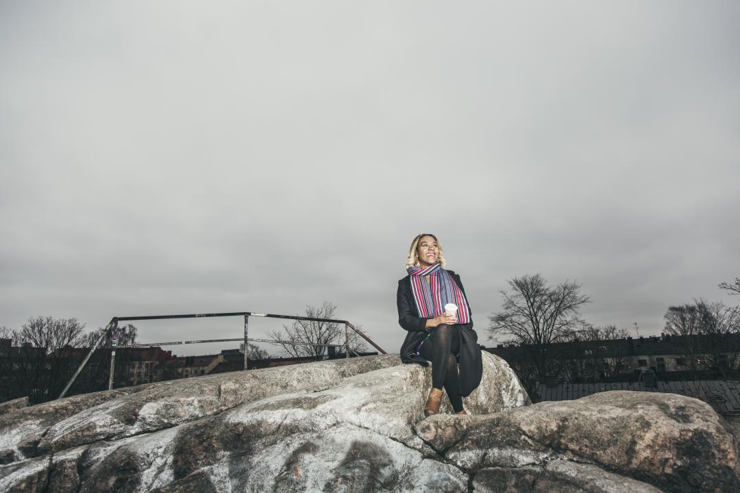 Woman sitting on a cliff