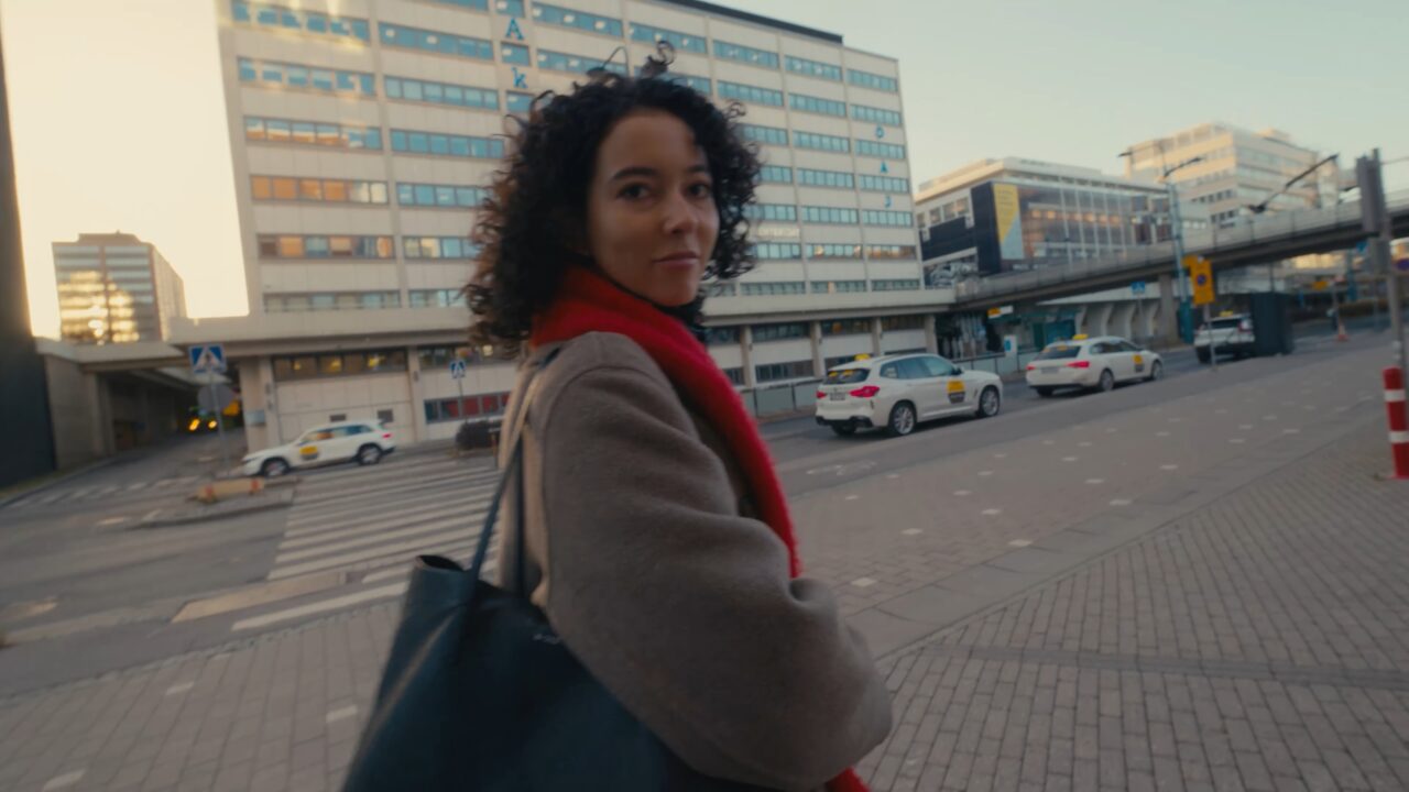 a woman standing on a sidewalk