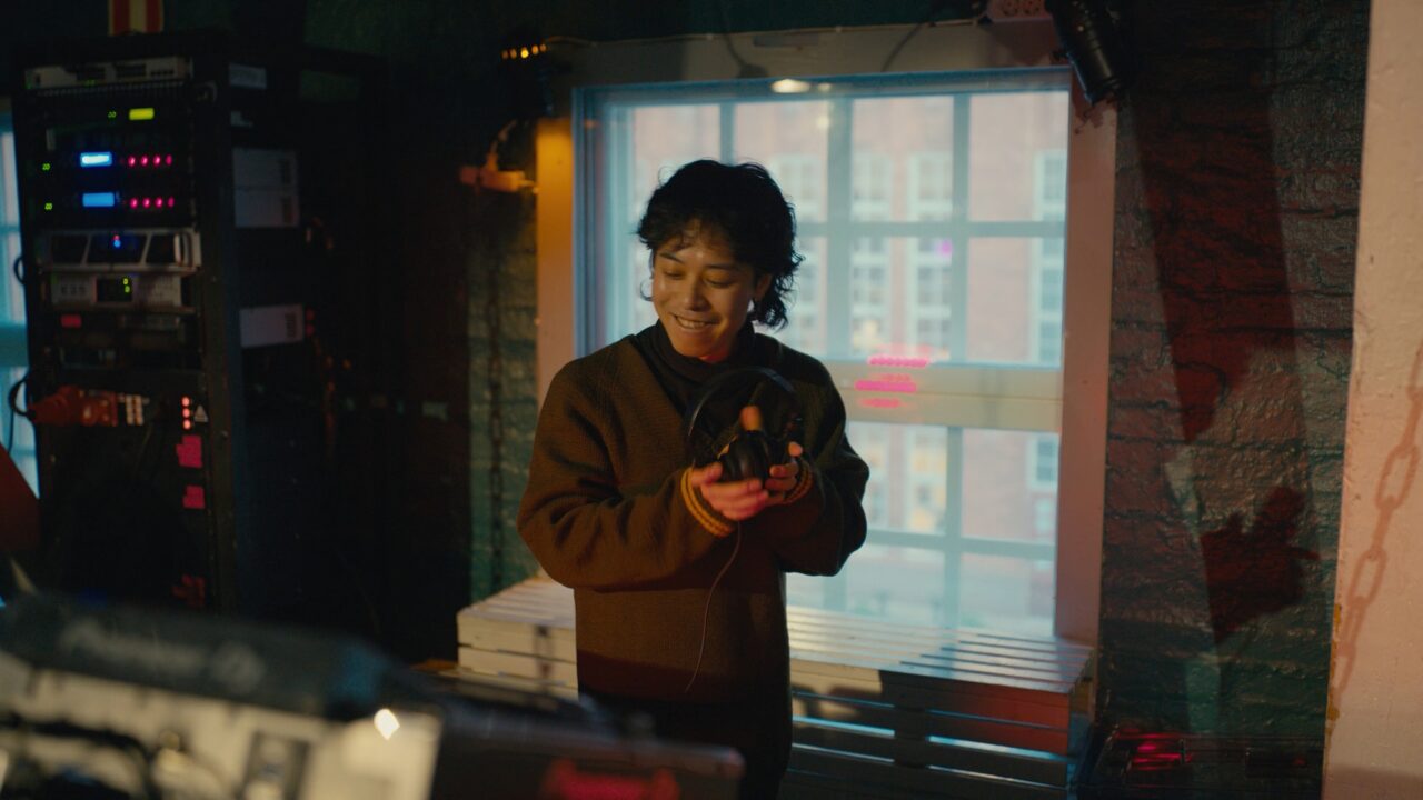 a person holding headphones in a dark room