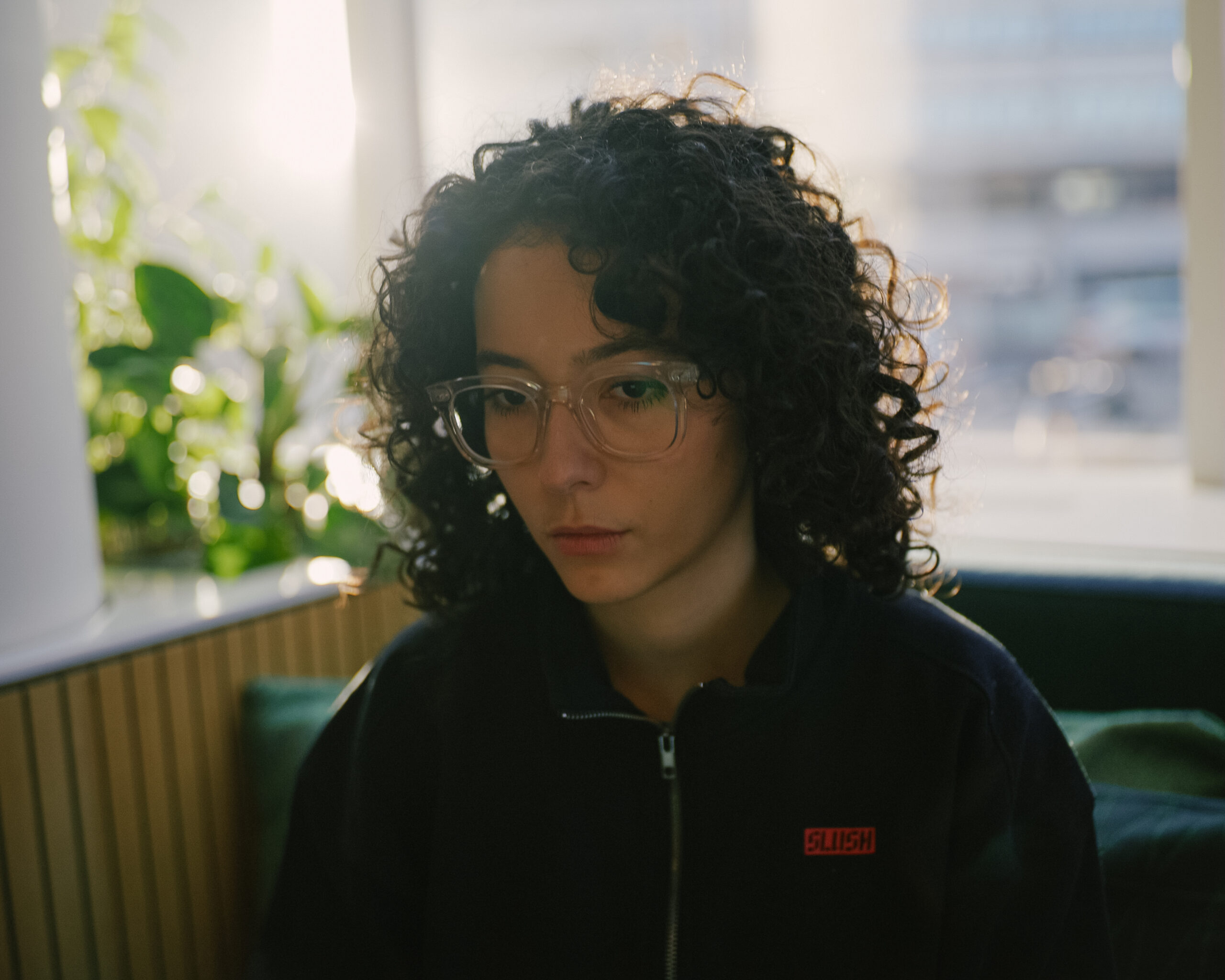 a woman with curly hair wearing glasses