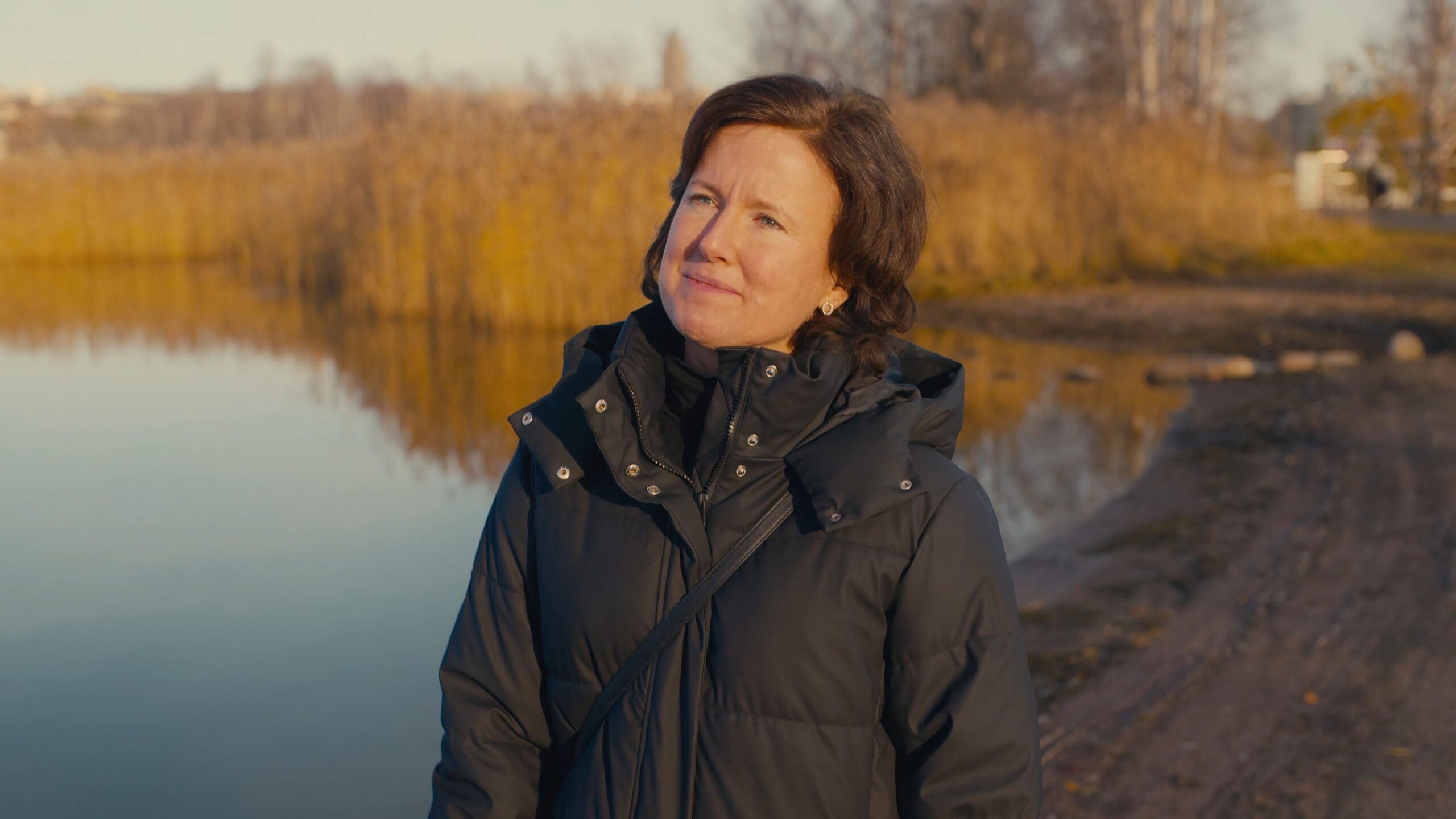 a woman standing near water