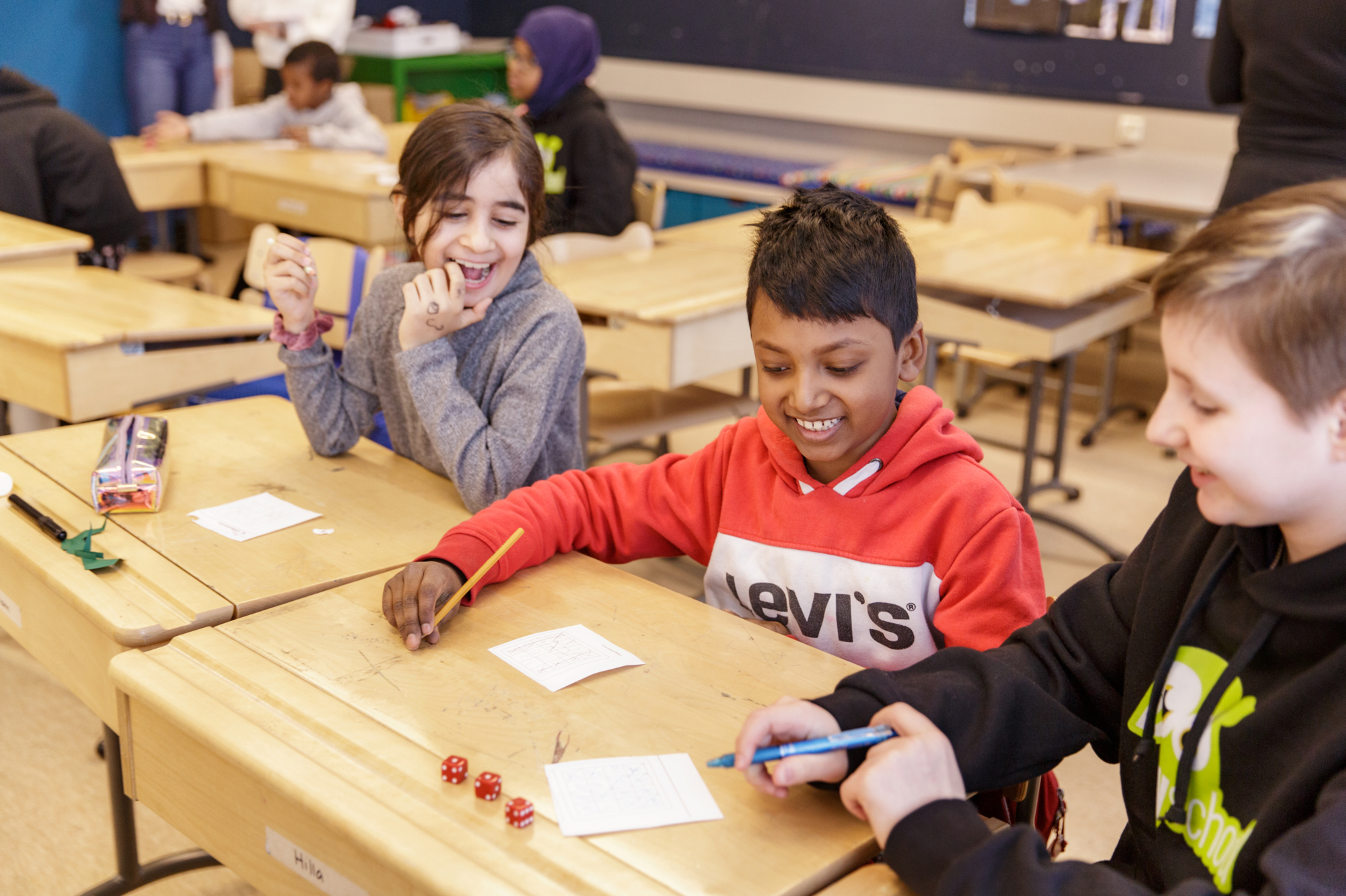 a group of children sitting at a desk