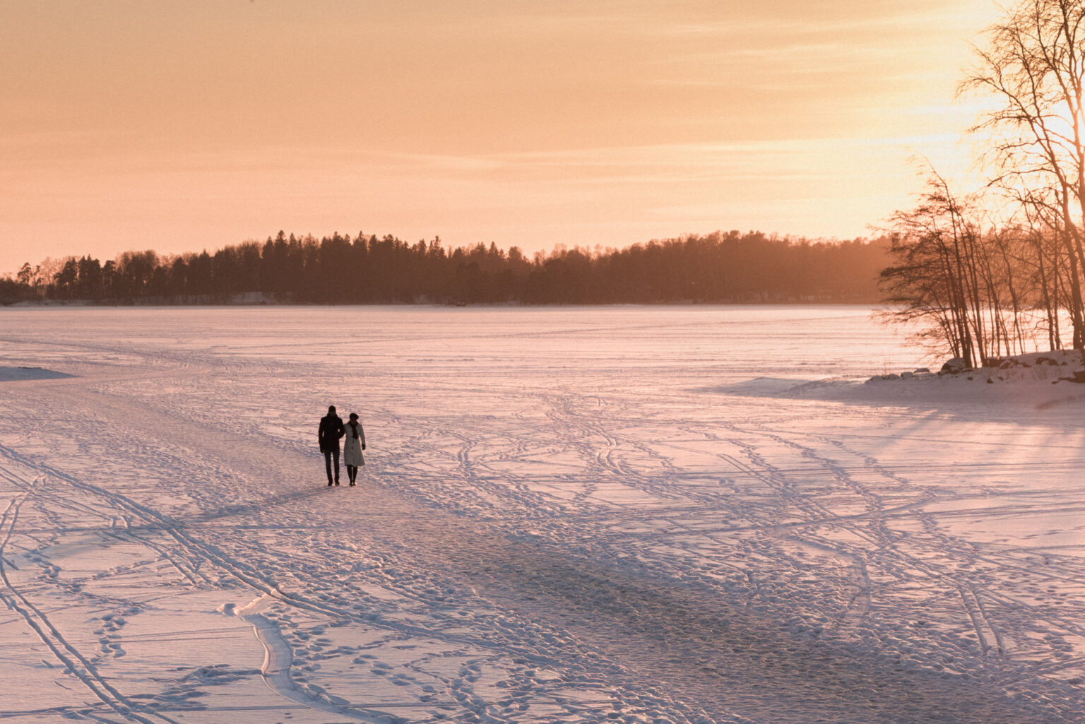 Couple walking on ice near Seurasaari island