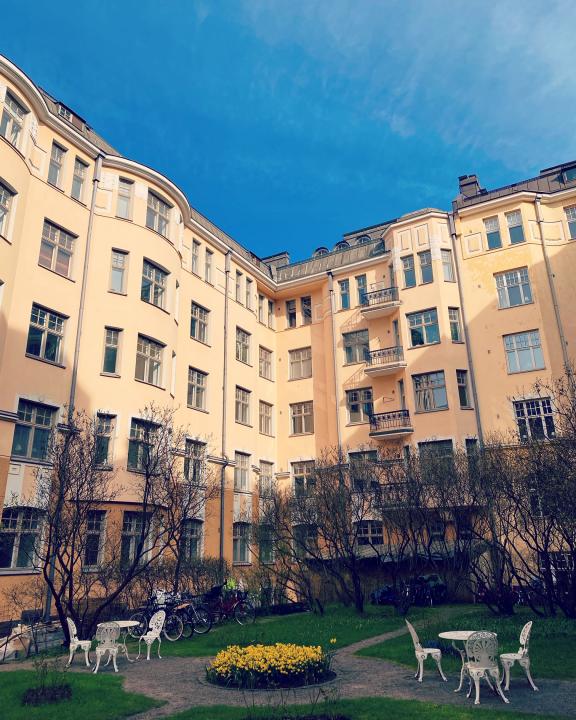 a building with a lawn and chairs